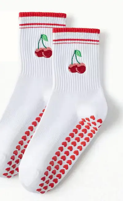 Custom white grip socks with cherry embroidery and heart-shaped sole grips